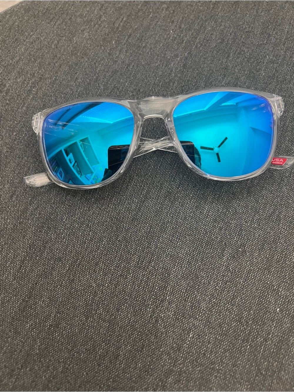 Oakley Clear Frame Sunglasses with Bright Blue Mirrored Lenses